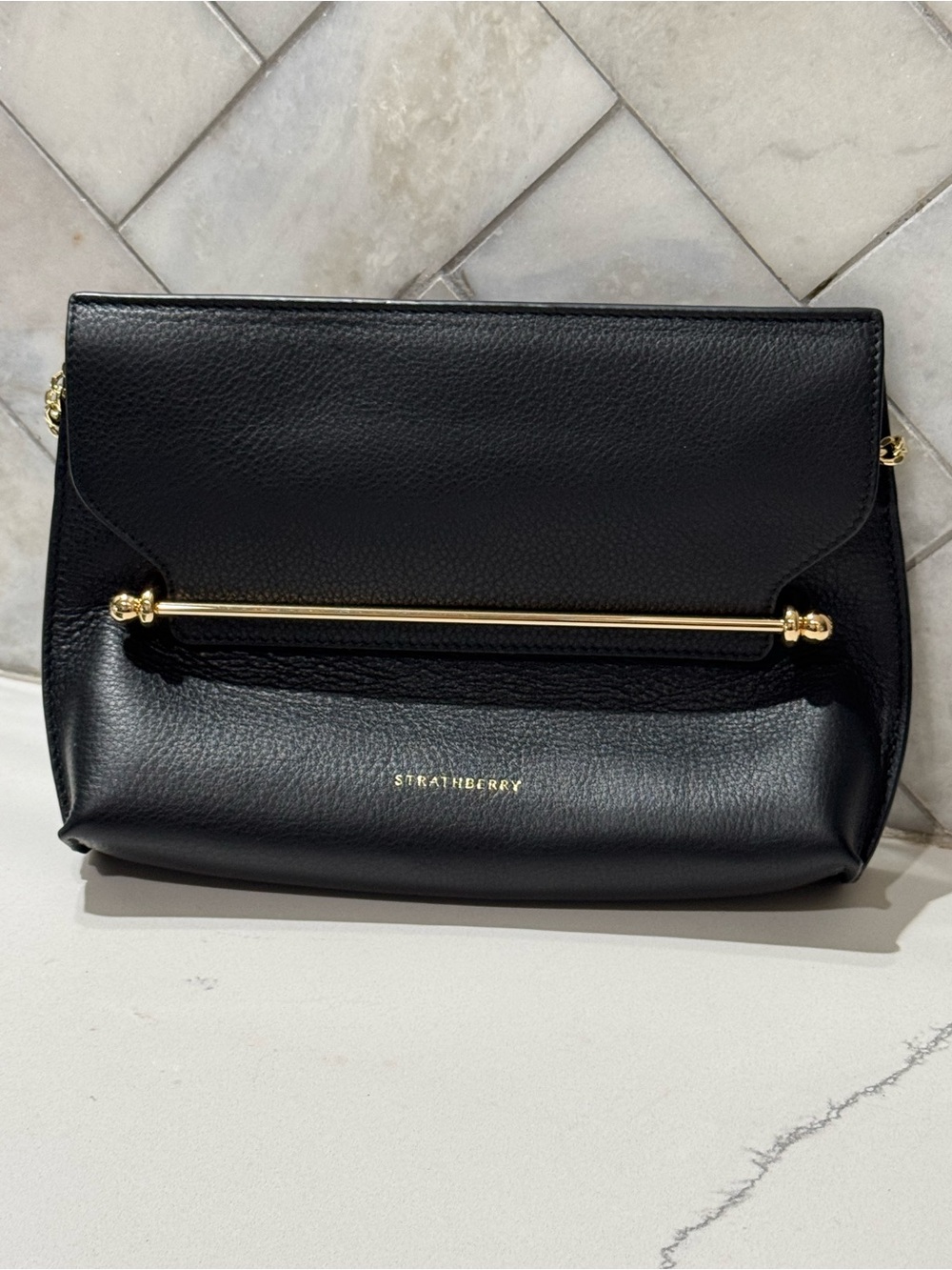 Strathberry Black Leather Stylist crossbody clutch with gold chain strap